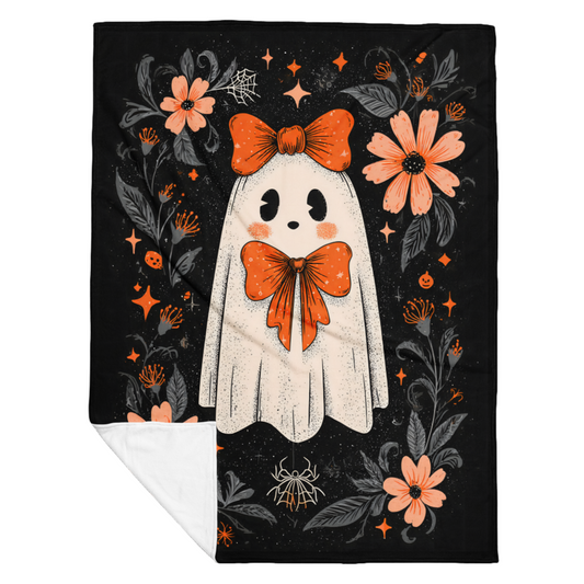 Halloween-themed blanket with ghost, flowers, and leaves on a black background